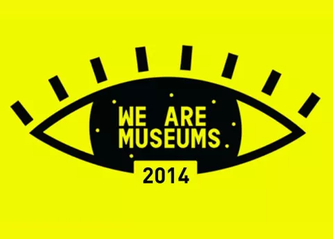 L'image représente un œil stylisé de couleur noire sur un fond jaune vif. À l'intérieur de l'œil, on peut lire l'inscription "WE ARE MUSEUMS" en lettres blanches. En dessous, l'année "2014" est écrite en noir. Le design est moderne et graphique, attirant l'attention grâce à ses couleurs contrastées.